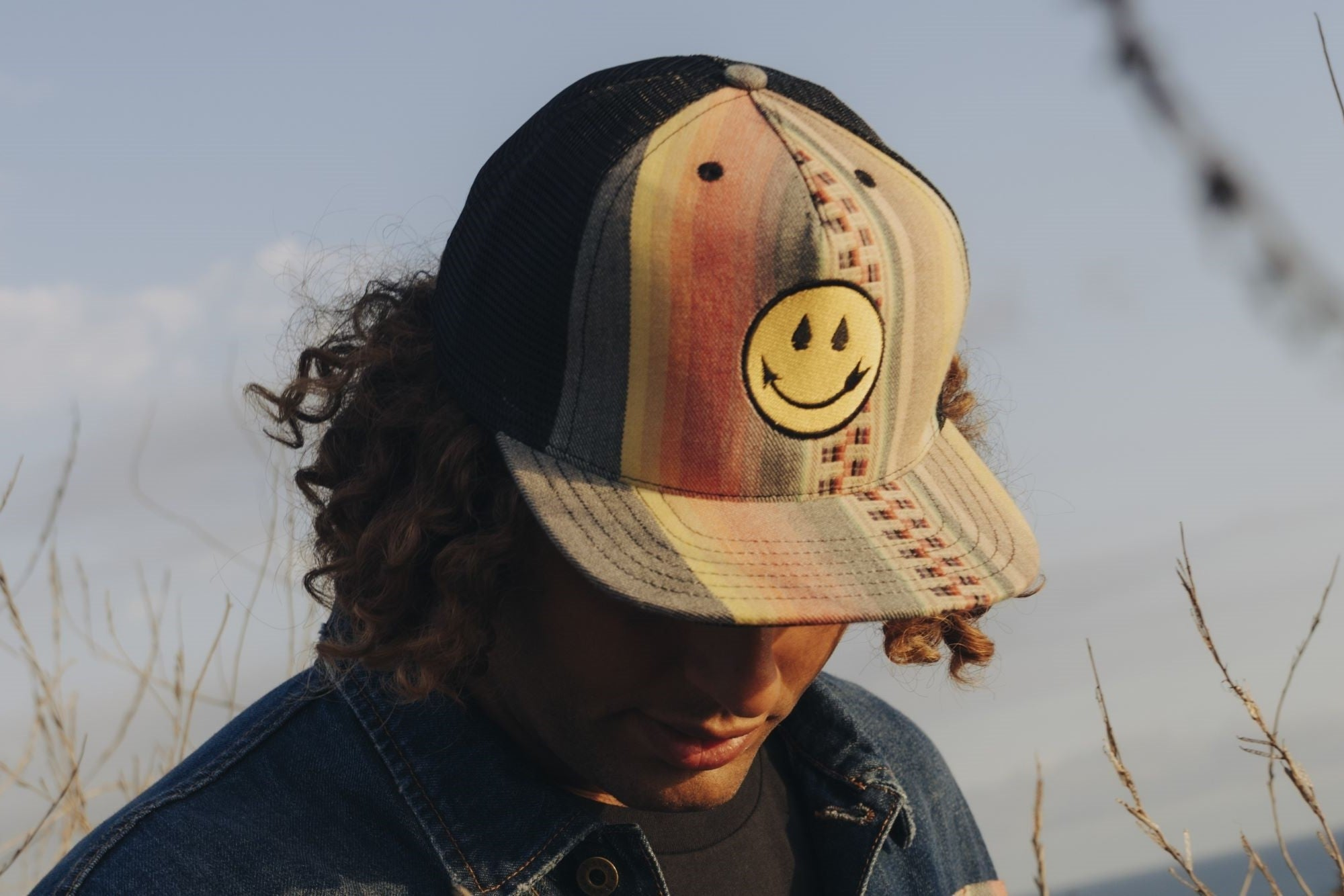 Colorful hat with smiling face arrow patch designed by Native American Steven Paul Judd