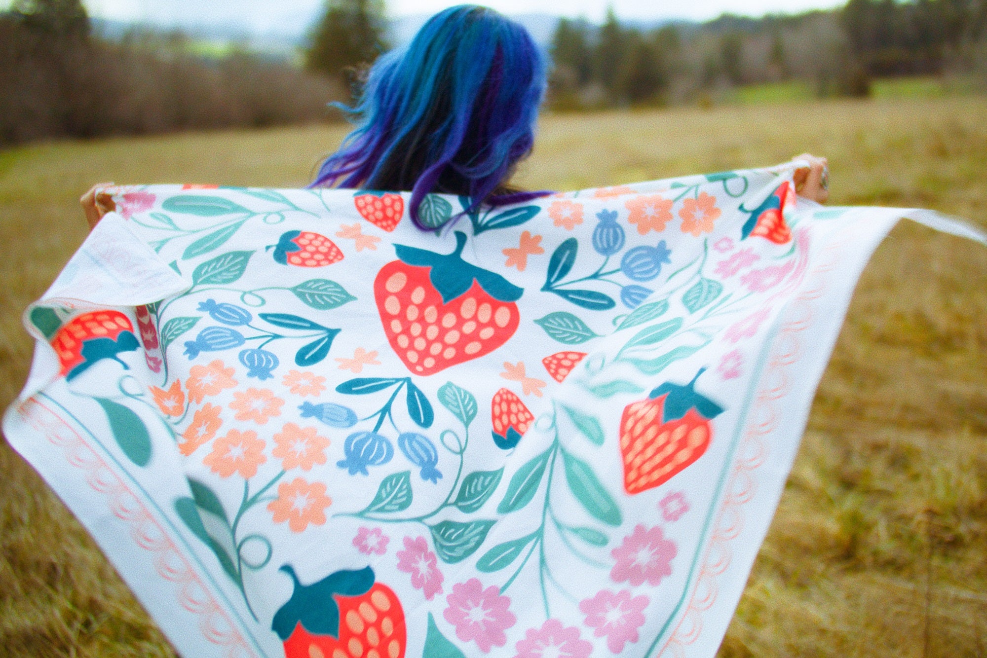 Native American Ginew Oneida Strawberry Wild Rag held by Native model in field