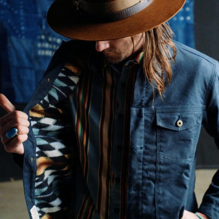 Black Ginew lined wax canvas coat on man 